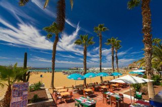 Enjoy a bite to eat at a beach side bar in Puerto Rico in Gran Canaria, Canary Islands